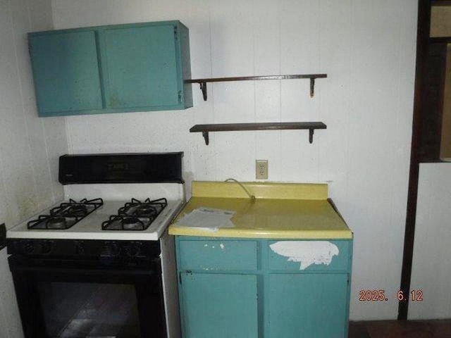 822 Robin Rd, Loyalhanna, PA 15681 - kitchen featuring range with gas stovetop, open shelves, blue cabinetry, and light countertops