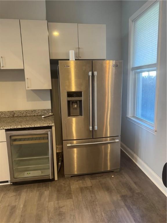 2411 Sarah St, South Side, PA 15203 - kitchen with stainless steel fridge, white cabinets, wine cooler, and dark wood-type flooring