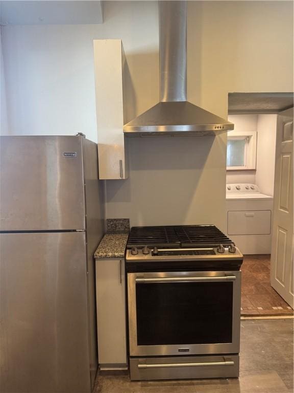 2411 Sarah St, South Side, PA 15203 - kitchen with appliances with stainless steel finishes, wall chimney exhaust hood, washer / clothes dryer, and stone countertops