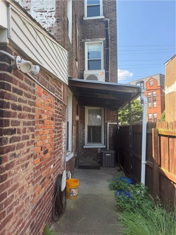 2411 Sarah St, South Side, PA 15203 - view of property exterior with brick siding and a cooling unit