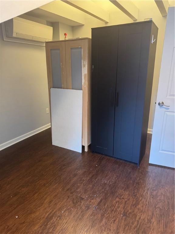 2411 Sarah St, South Side, PA 15203 - empty room featuring an AC wall unit and wood finished floors
