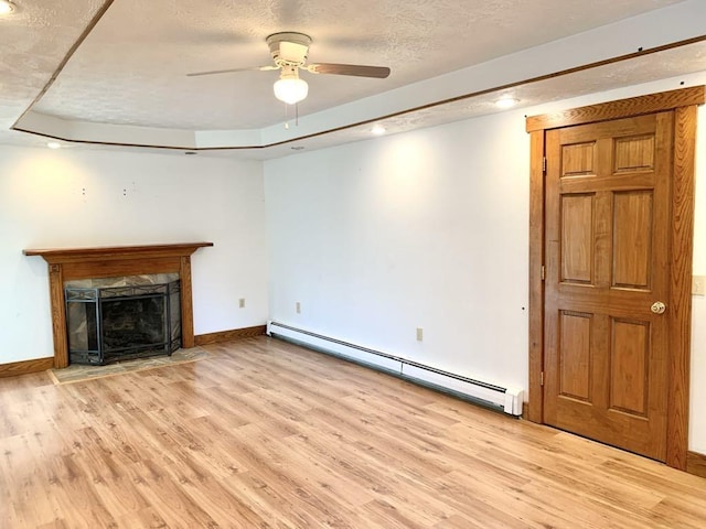 840 Lansberry Ct, Somerset Boro, PA 15501 - unfurnished living room featuring a baseboard radiator, light wood-type flooring, ceiling fan, a fireplace, and a textured ceiling