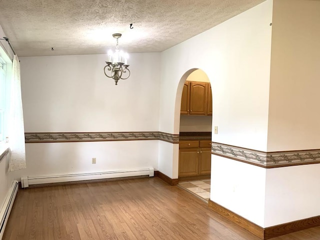 840 Lansberry Ct, Somerset Boro, PA 15501 - spare room with a baseboard radiator, light wood finished floors, a chandelier, and a textured ceiling
