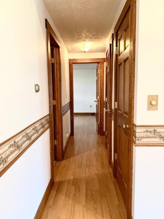 840 Lansberry Ct, Somerset Boro, PA 15501 - hallway featuring a textured ceiling and light wood finished floors