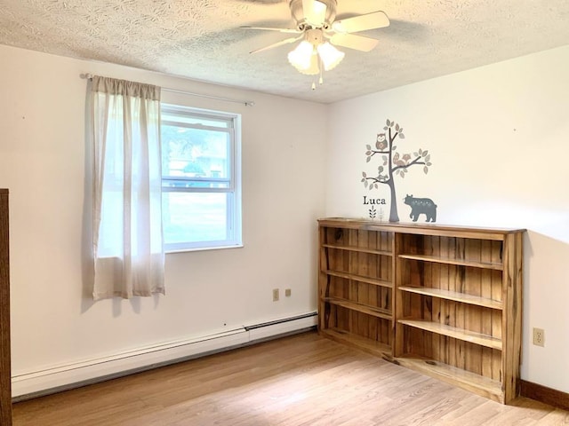 840 Lansberry Ct, Somerset Boro, PA 15501 - empty room featuring a baseboard radiator, a textured ceiling, wood finished floors, and a ceiling fan