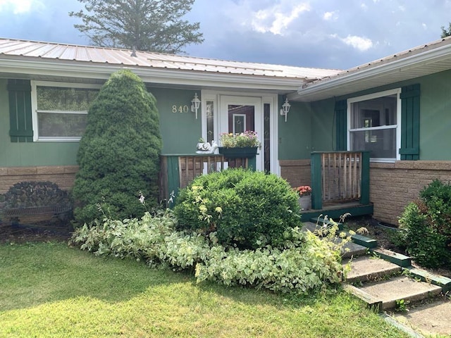 840 Lansberry Ct, Somerset Boro, PA 15501 - doorway to property with brick siding, a metal roof, and a yard