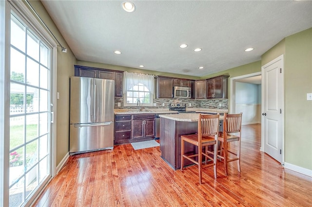 102 Bridal Ln, North Fayette, PA 15071 - kitchen with stainless steel appliances, light countertops, light wood finished floors, tasteful backsplash, and recessed lighting