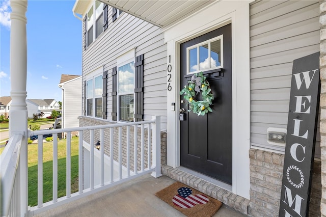 1026 Tee Line Dr, Hopewell Twp, PA 15001 - view of exterior entry with covered porch and a yard