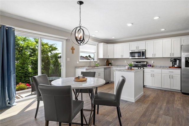 1026 Tee Line Dr, Hopewell Twp, PA 15001 - kitchen with appliances with stainless steel finishes, crown molding, a kitchen island, white cabinets, and wood finished floors