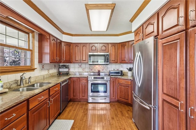 221 Scott Hollow Rd, Pa, PA 15021 - kitchen featuring stainless steel appliances, light stone countertops, light wood-style floors, tasteful backsplash, and brown cabinets