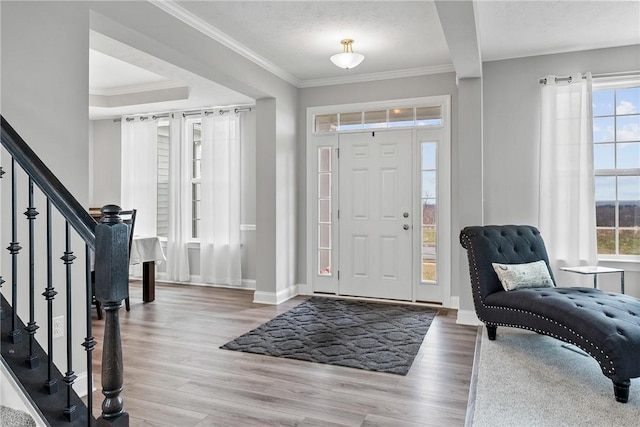 107 Valley View Dr, Brighton Twp, PA 15009 - foyer entrance featuring healthy amount of natural light, wood finished floors, ornamental molding, and stairs