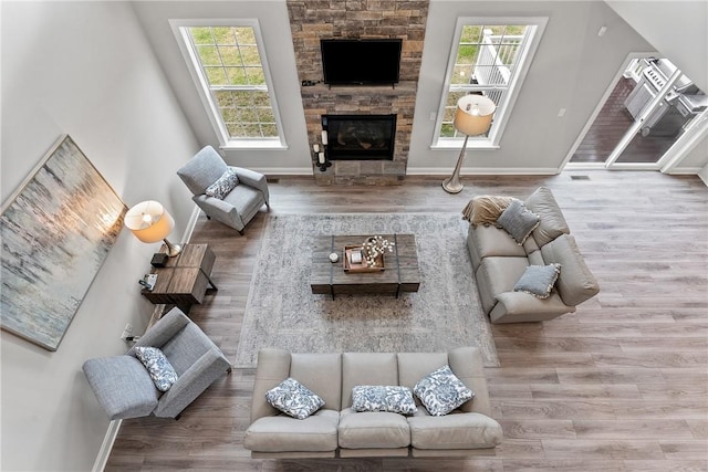107 Valley View Dr, Brighton Twp, PA 15009 - living room featuring healthy amount of natural light, wood finished floors, and a stone fireplace