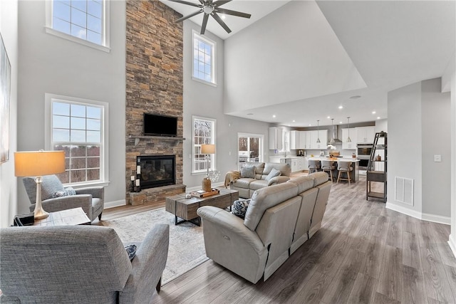 107 Valley View Dr, Brighton Twp, PA 15009 - living room with a high ceiling, a ceiling fan, wood finished floors, and a fireplace
