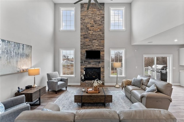 107 Valley View Dr, Brighton Twp, PA 15009 - living area with a high ceiling, ceiling fan, wood finished floors, and a stone fireplace