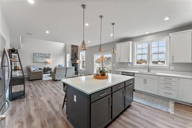 107 Valley View Dr, Brighton Twp, PA 15009 - kitchen featuring white cabinets, light wood-type flooring, light countertops, a kitchen island, and recessed lighting