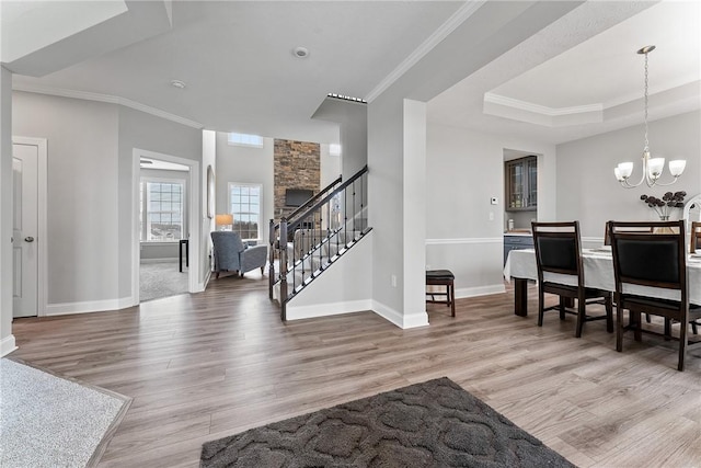 107 Valley View Dr, Brighton Twp, PA 15009 - foyer entrance featuring wood finished floors, stairway, a chandelier, crown molding, and a raised ceiling