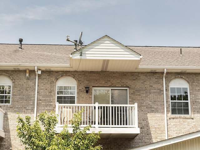 25 Elena Ave Unit 25, Lower Burrell, PA 15068 - back of property featuring a balcony, brick siding, and roof with shingles
