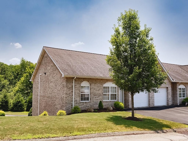 25 Elena Ave Unit 25, Lower Burrell, PA 15068 - view of front facade featuring driveway, roof with shingles, brick siding, a garage, and a front lawn