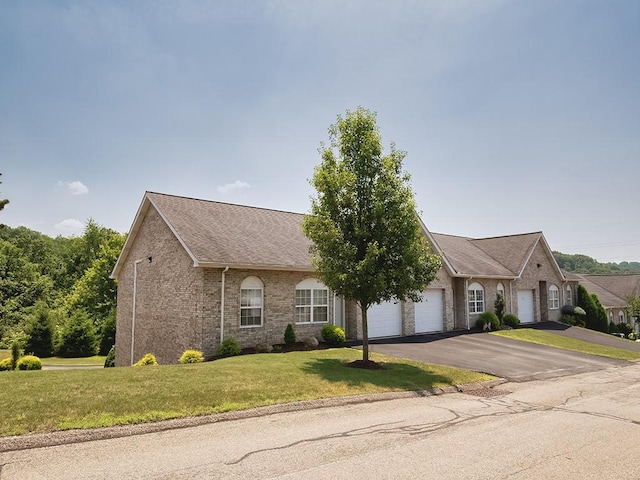 25 Elena Ave Unit 25, Lower Burrell, PA 15068 - view of front facade featuring a garage, a front yard, brick siding, driveway, and a shingled roof