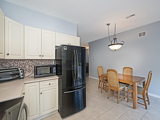 25 Elena Ave Unit 25, Lower Burrell, PA 15068 - kitchen featuring freestanding refrigerator, tasteful backsplash, light tile patterned floors, light countertops, and white cabinets