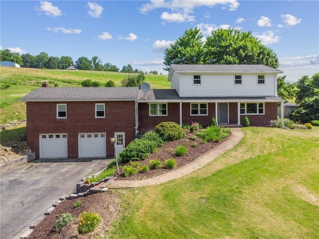 359 Meadow Spring Rd, Unity Twp, PA 15650 - traditional-style house featuring driveway, a garage, brick siding, and a front yard