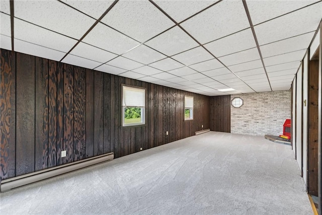 359 Meadow Spring Rd, Unity Twp, PA 15650 - unfurnished room with a baseboard heating unit, carpet flooring, a paneled ceiling, and wooden walls