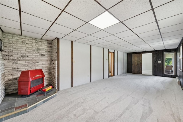 359 Meadow Spring Rd, Unity Twp, PA 15650 - below grade area featuring a wood stove, carpet, and a paneled ceiling