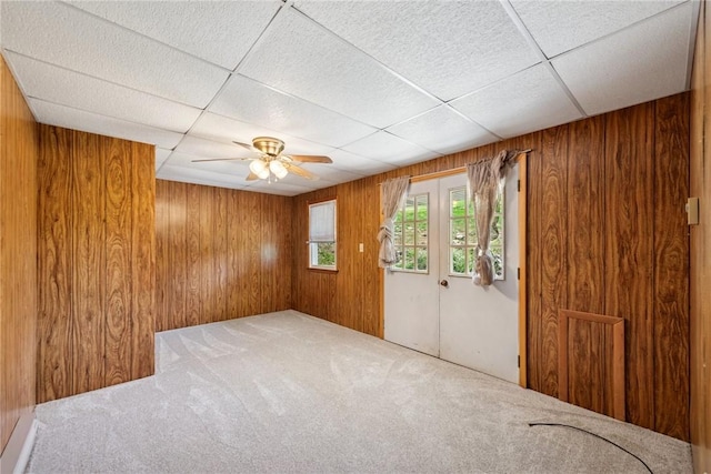 359 Meadow Spring Rd, Unity Twp, PA 15650 - unfurnished room featuring carpet, wood walls, ceiling fan, and a drop ceiling