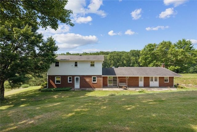 359 Meadow Spring Rd, Unity Twp, PA 15650 - rear view of property featuring a yard, brick siding, a patio area, a chimney, and french doors