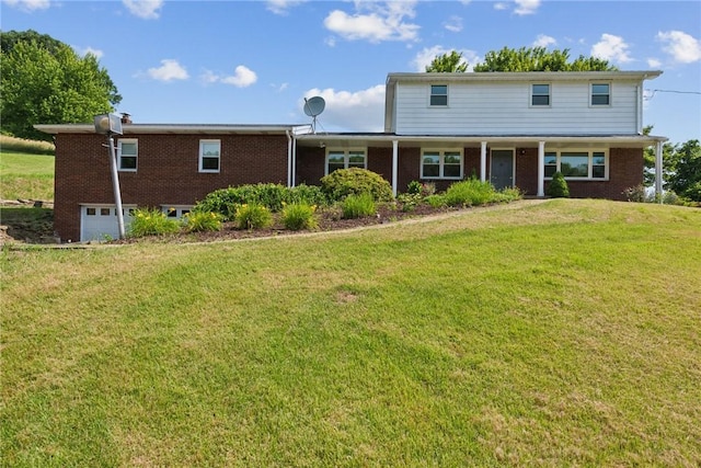 359 Meadow Spring Rd, Unity Twp, PA 15650 - view of front facade with brick siding, a garage, and a front lawn