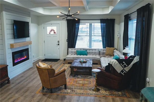 1053 Beaner Hollow Rd, Brighton Twp, PA 15009 - living room featuring coffered ceiling, wood finished floors, a glass covered fireplace, a chandelier, and beamed ceiling
