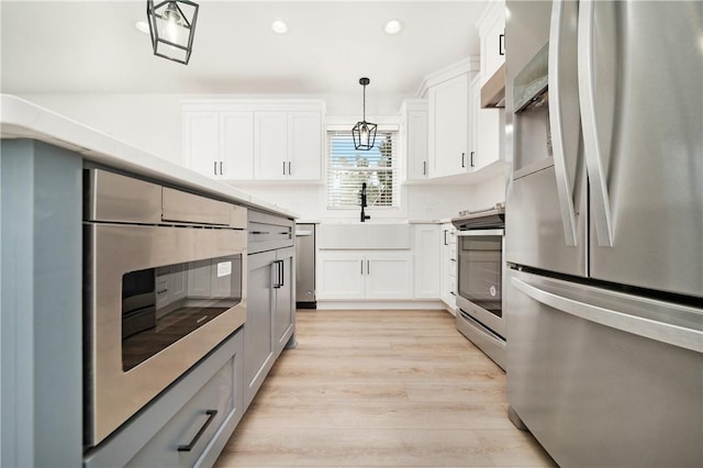 1053 Beaner Hollow Rd, Brighton Twp, PA 15009 - kitchen with appliances with stainless steel finishes, light wood finished floors, recessed lighting, light countertops, and decorative light fixtures