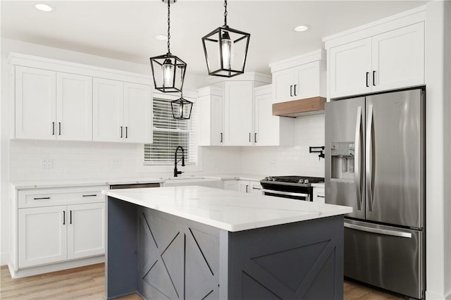 1053 Beaner Hollow Rd, Brighton Twp, PA 15009 - kitchen featuring appliances with stainless steel finishes, under cabinet range hood, light wood-type flooring, white cabinetry, and recessed lighting