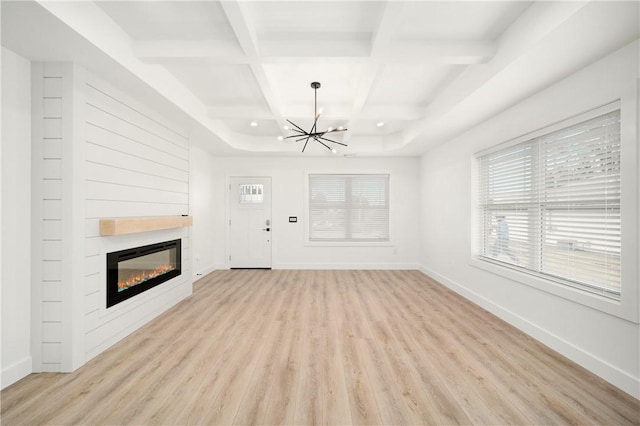 1053 Beaner Hollow Rd, Brighton Twp, PA 15009 - unfurnished living room with a chandelier, light wood-style floors, coffered ceiling, a glass covered fireplace, and beamed ceiling
