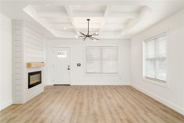 1053 Beaner Hollow Rd, Brighton Twp, PA 15009 - unfurnished living room with a chandelier, beamed ceiling, coffered ceiling, light wood-style floors, and a fireplace