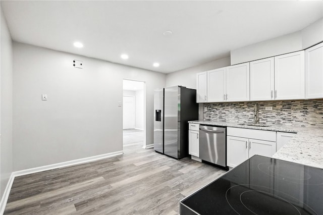 1014 Deerfield Dr, Elizabeth Twp/Boro, PA 15037 - kitchen featuring stainless steel appliances, light wood-type flooring, white cabinetry, tasteful backsplash, and recessed lighting