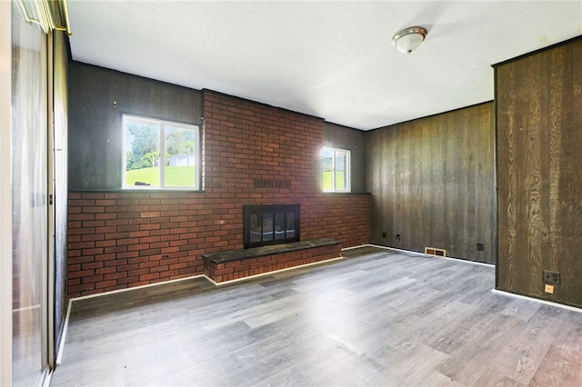 1014 Deerfield Dr, Elizabeth Twp/Boro, PA 15037 - unfurnished living room featuring wood finished floors, a brick fireplace, and brick wall