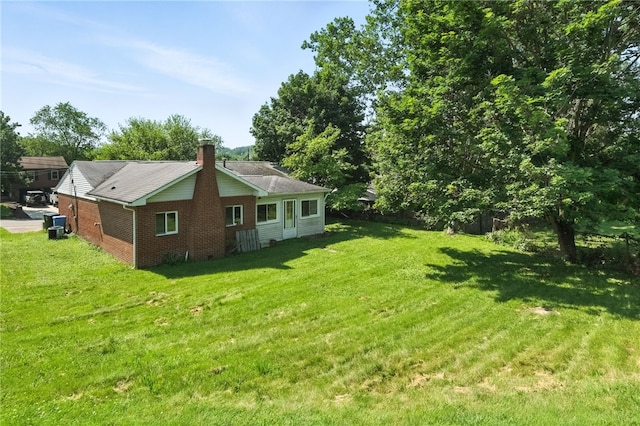 1014 Deerfield Dr, Elizabeth Twp/Boro, PA 15037 - view of side of home featuring brick siding, a lawn, and a chimney