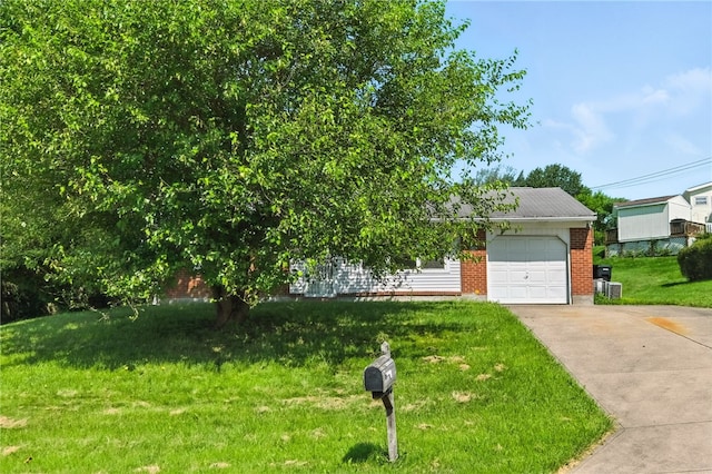 1014 Deerfield Dr, Elizabeth Twp/Boro, PA 15037 - view of property hidden behind natural elements featuring brick siding, concrete driveway, a garage, and a front yard
