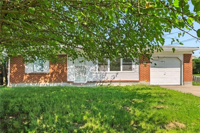 1014 Deerfield Dr, Elizabeth Twp/Boro, PA 15037 - obstructed view of property featuring an attached garage, brick siding, a front lawn, and concrete driveway