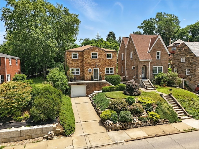 144 Cochran Mt, Lebanon, PA 15228 - view of front facade with a garage, stairs, concrete driveway, and brick siding