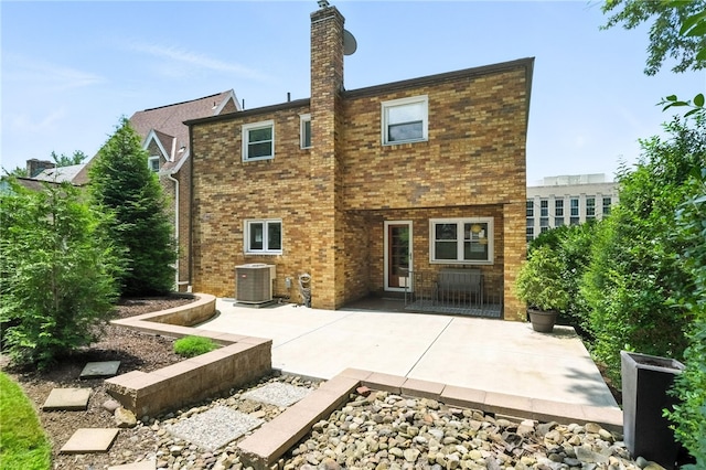 144 Cochran Mt, Lebanon, PA 15228 - back of house with a patio, brick siding, and a chimney