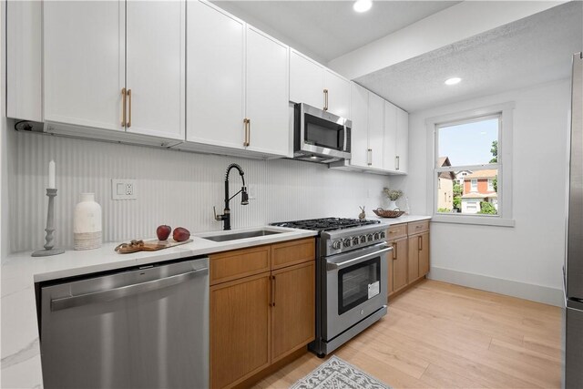 3246 Piedmont Ave, Dormont, PA 15216 - kitchen featuring stainless steel appliances, light countertops, white cabinetry, light wood-style floors, and recessed lighting