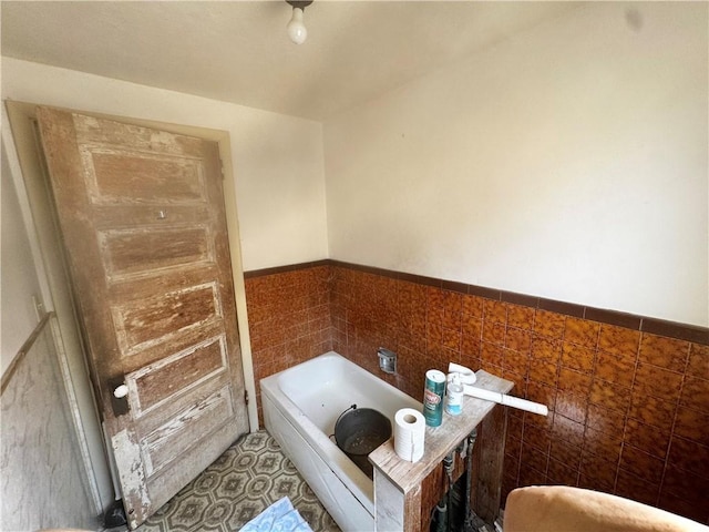 706 Lincoln St, Monongahela, PA 15063 - full bath featuring a bath, a wainscoted wall, and tile walls