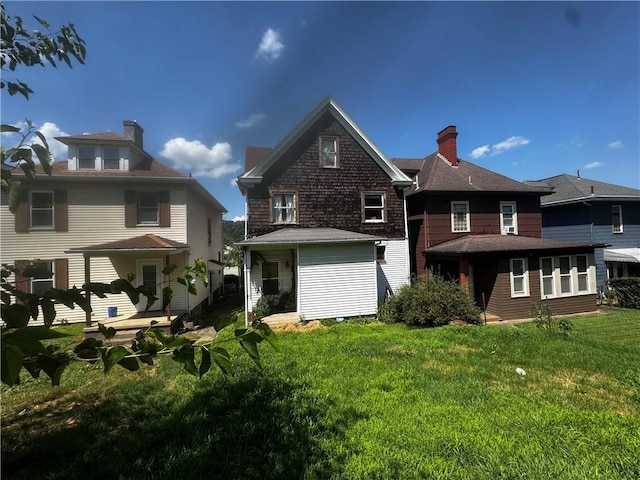 706 Lincoln St, Monongahela, PA 15063 - back of property with a lawn and a chimney