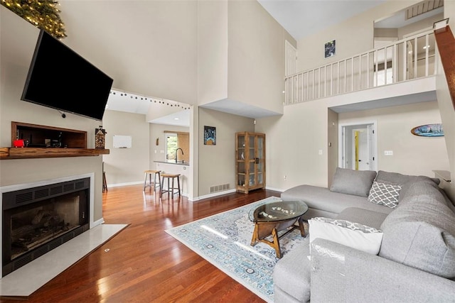 121 Fairway Landings Dr, Cecil, PA 15317 - living room with wood finished floors, a fireplace with flush hearth, and a high ceiling