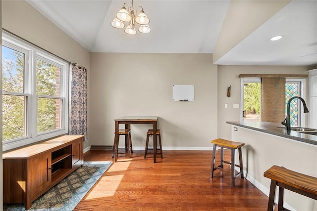 121 Fairway Landings Dr, Cecil, PA 15317 - dining room featuring lofted ceiling, a chandelier, dark wood-style floors, plenty of natural light, and recessed lighting