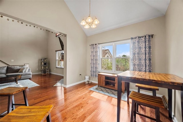 121 Fairway Landings Dr, Cecil, PA 15317 - dining area featuring light wood-style flooring, high vaulted ceiling, and a chandelier