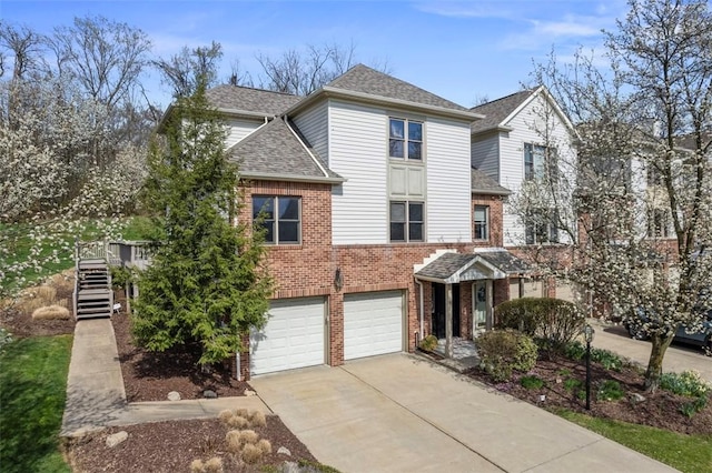 121 Fairway Landings Dr, Cecil, PA 15317 - view of front of house with concrete driveway, brick siding, an attached garage, roof with shingles, and stairs