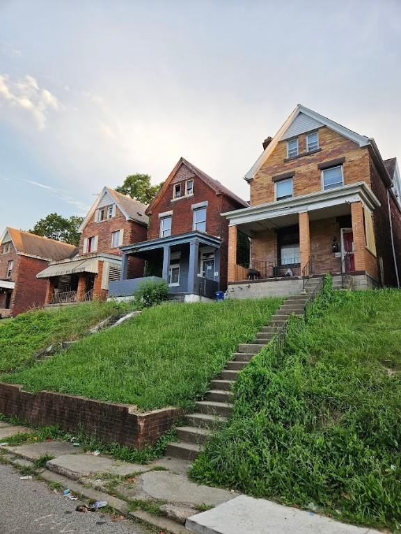 324 Moore Ave, Knoxville, PA 15210 - back of house featuring stairway, a porch, and brick siding